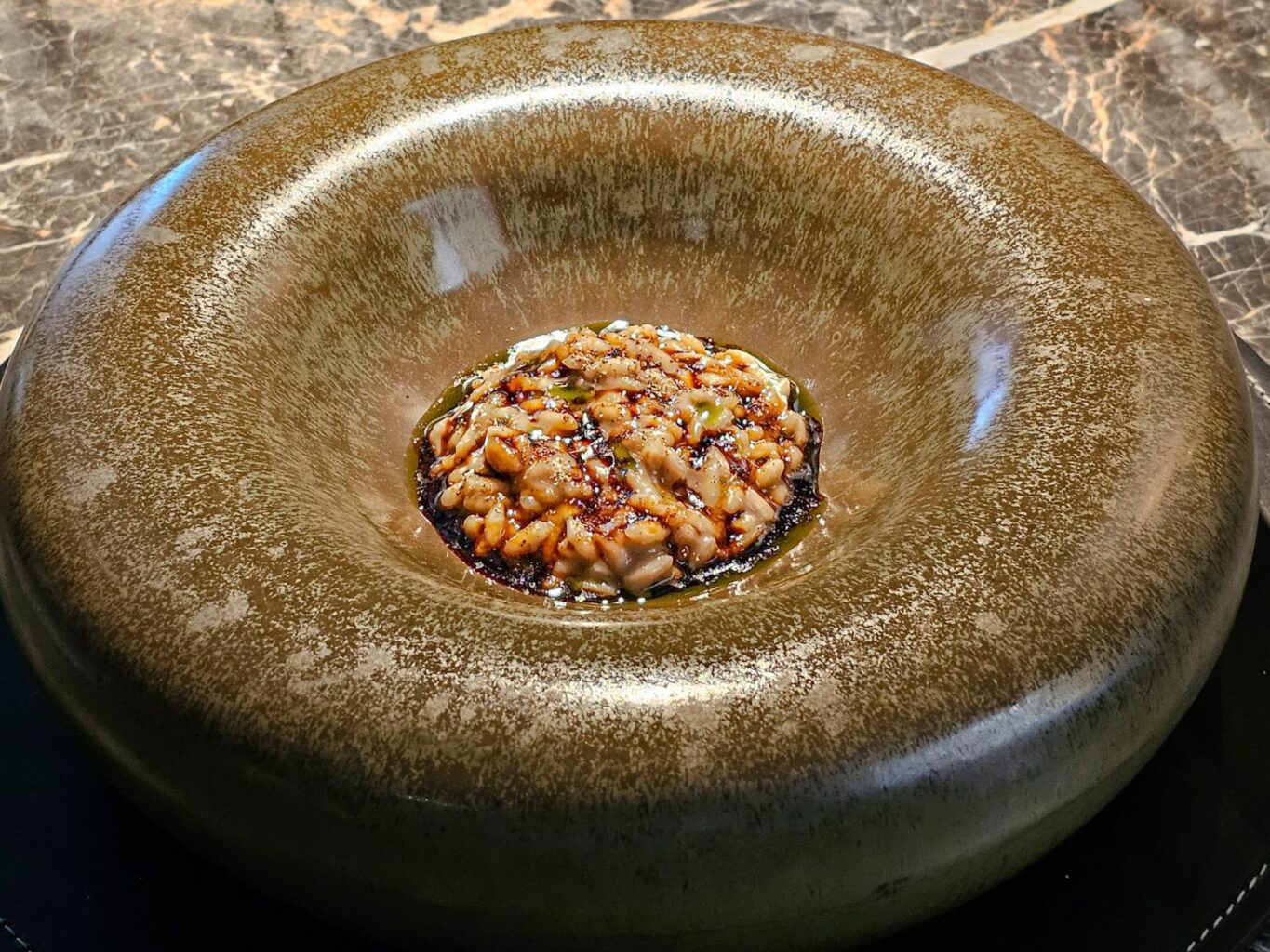 Risotto, germano reale, shiitake, alloro del ristorante Wisteria.