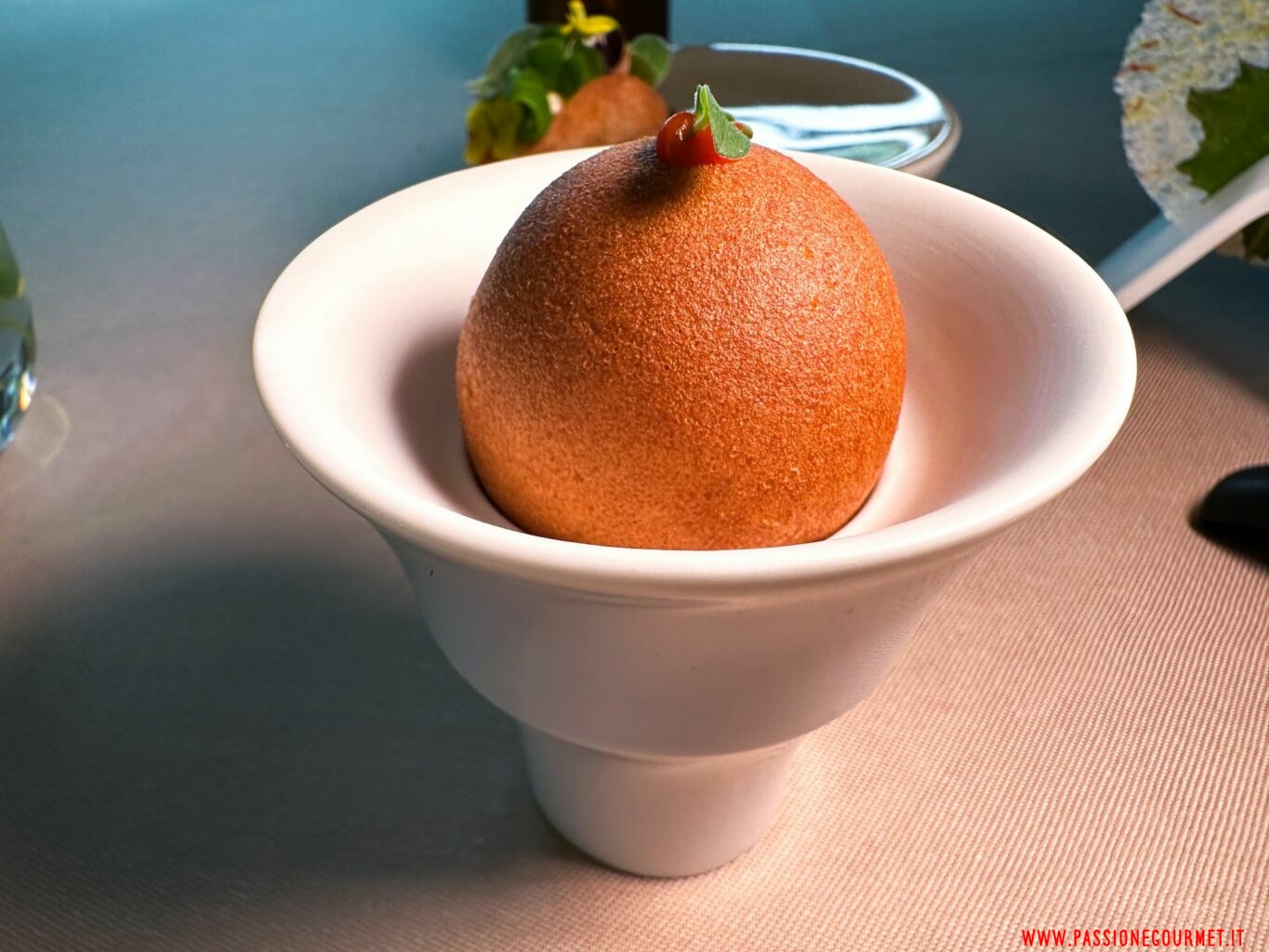 Sfera di farina di ceci con lumache, pomodoro e cipolla all'interno.