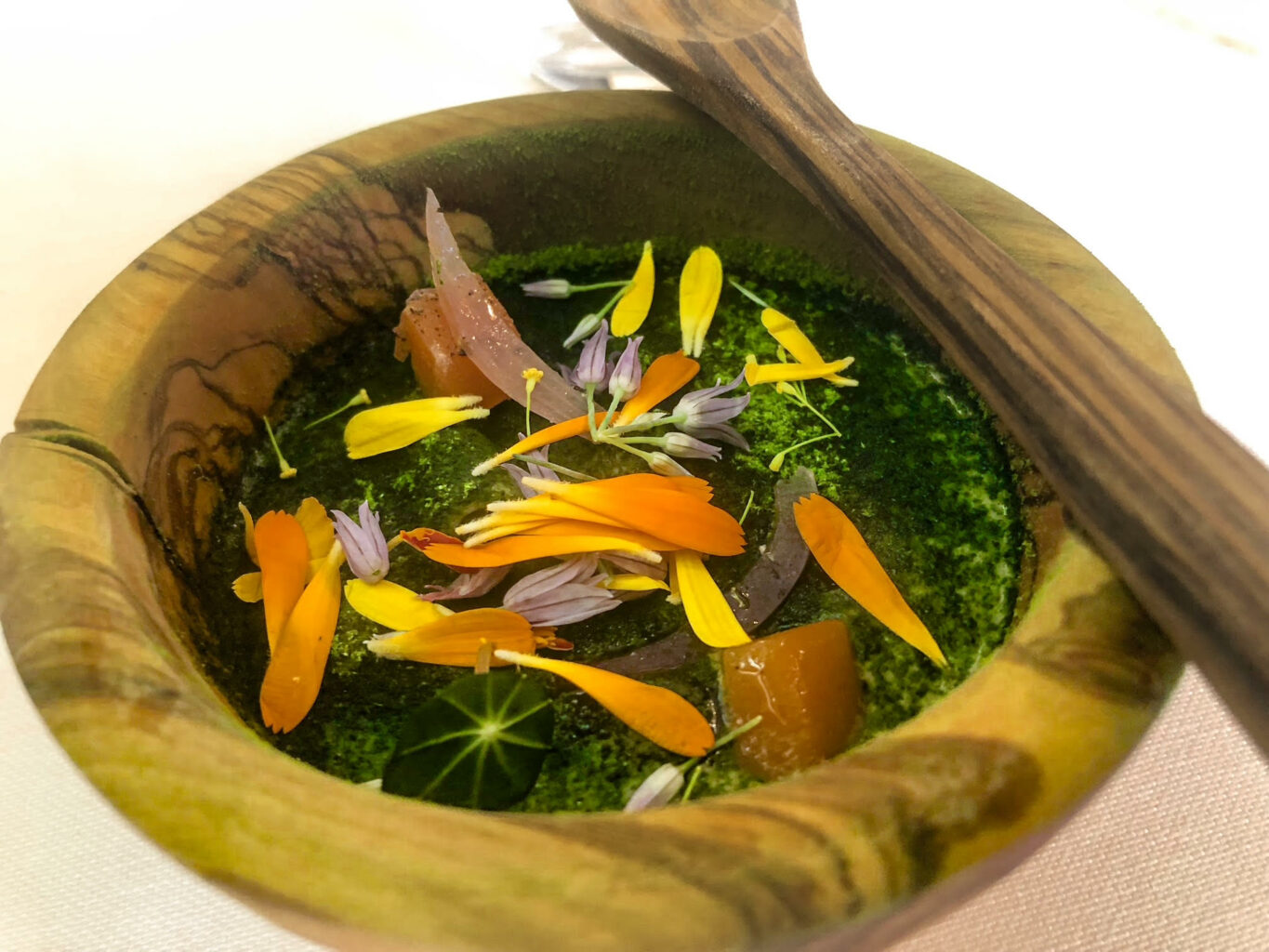 Pasta e patate, cotte in un centrifugato di patate cotte alla brace, nasturzio, cipolle marinate, scalogno fermentato, carote cotte nell’aceto, fiori eduli.