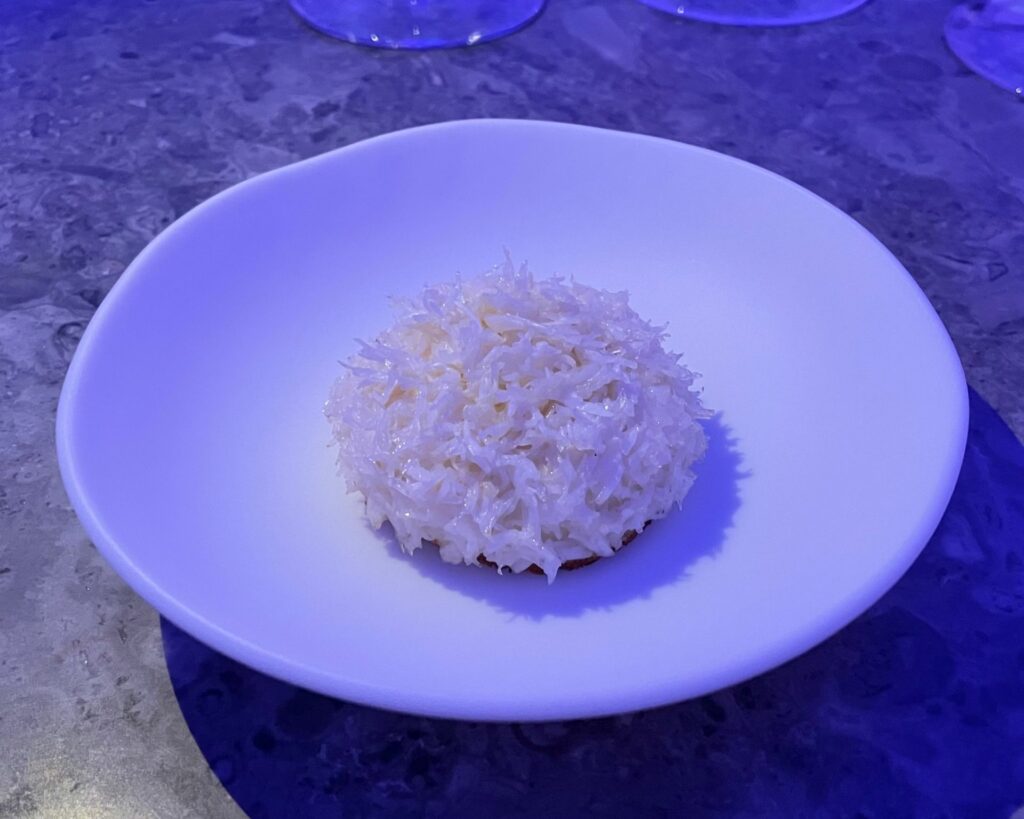 Crab toast dell'Alchemist, in cima: polpa di chele di granchio delicatamente scottata, sotto una farcia a base di capesante, il contenuto del carapace del granchio e olio di sesamo. Al centro: una salsa XO ricavata dai carapaci del granchio, guarnita con una salsa blanquette aromatizzata con lime, galanga e peperoncino rosso.
