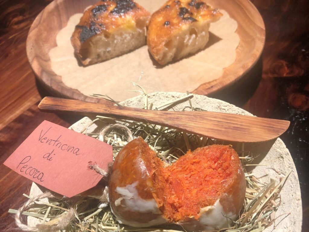 Ventricina di pecora con peperone crusco, finocchietto e pepe, focaccia al vapore e terminata al barbecue.