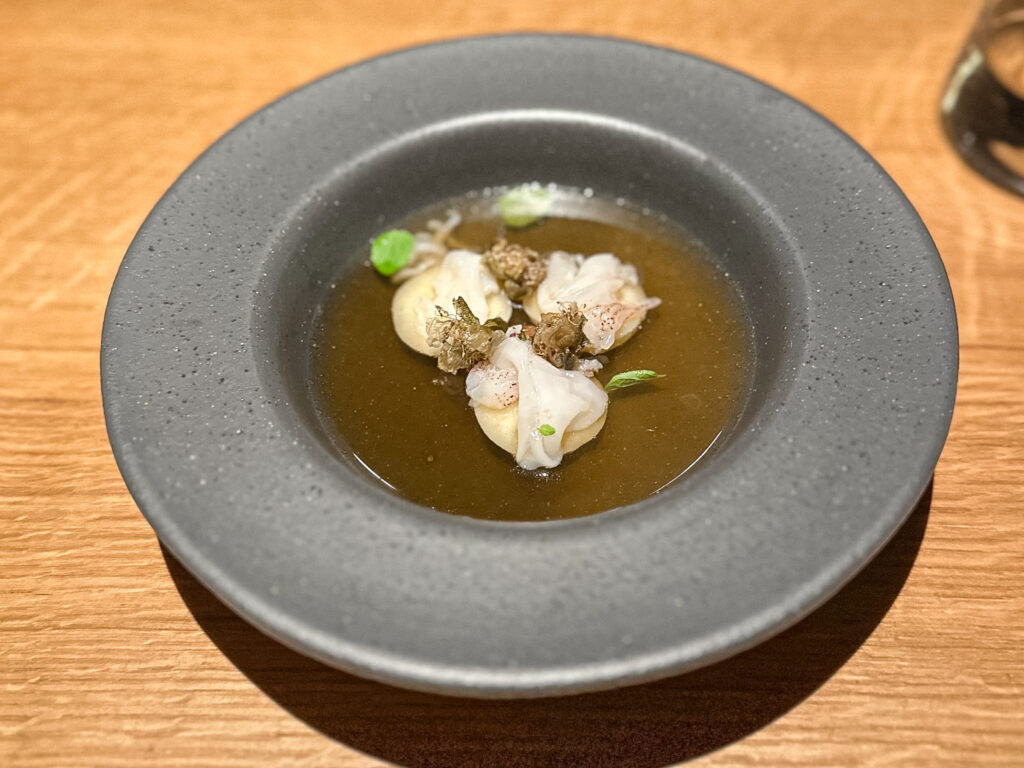 Anolini di stoccafisso, calamaretti e pomodorino del Piennolo.
