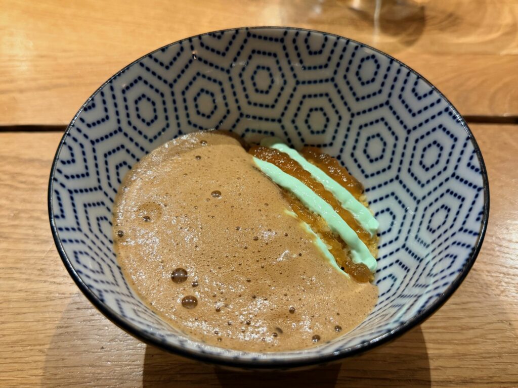 Cous cous agli agrumi e fiori d’arancio, rafano e jus di crostacei con scorze d’arancia bruciate