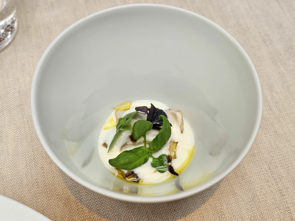 Il secondo servizio della seppia, con acqua di burrata, lemongrass, zenzero e foglie di basilico.
